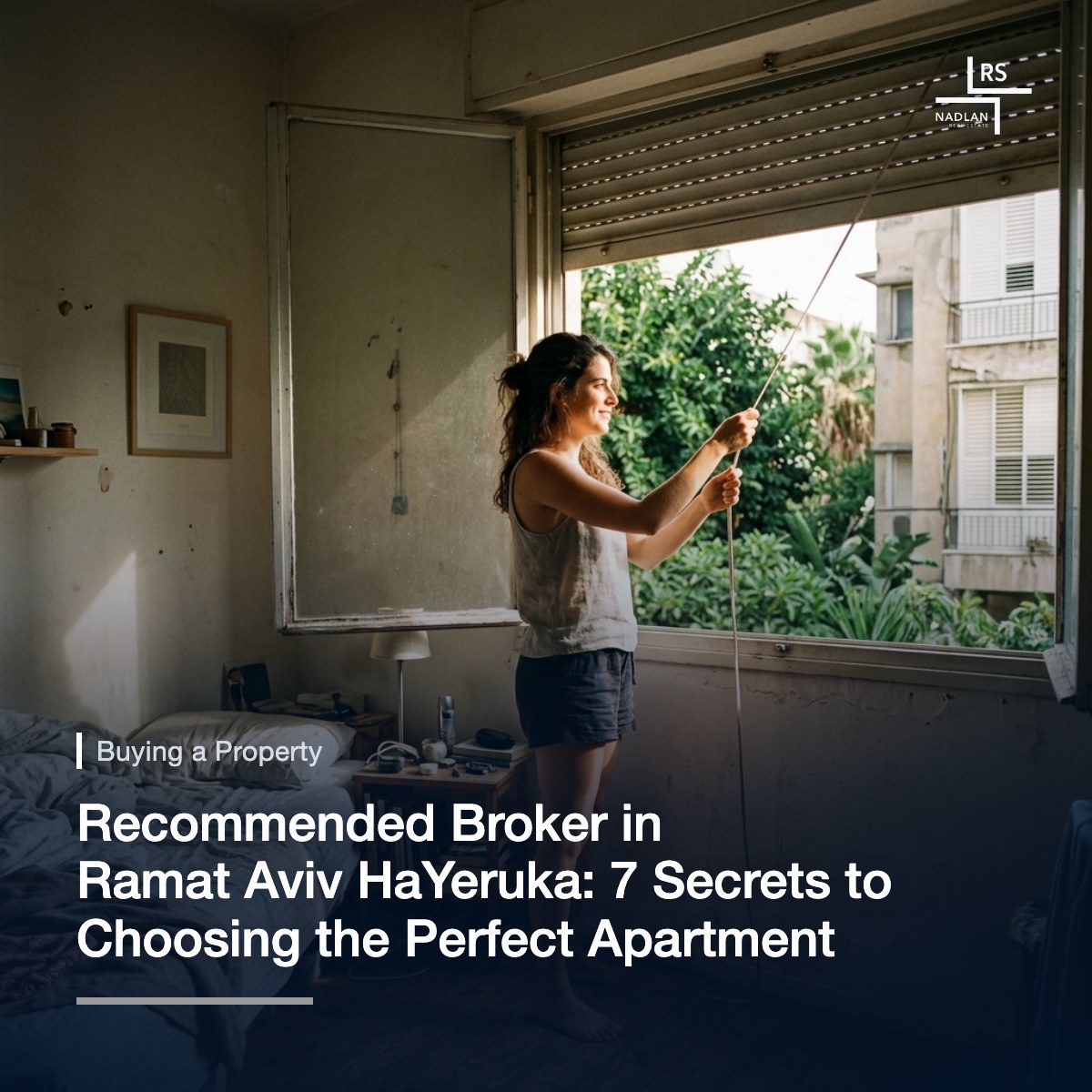 From inside a bedroom, a woman rolling up the aluminum shutter in the morning
