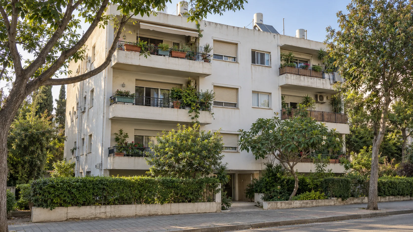 A 1970s apartment block in Herzliya HaTzeira, with balconies and trees in front (illustration)